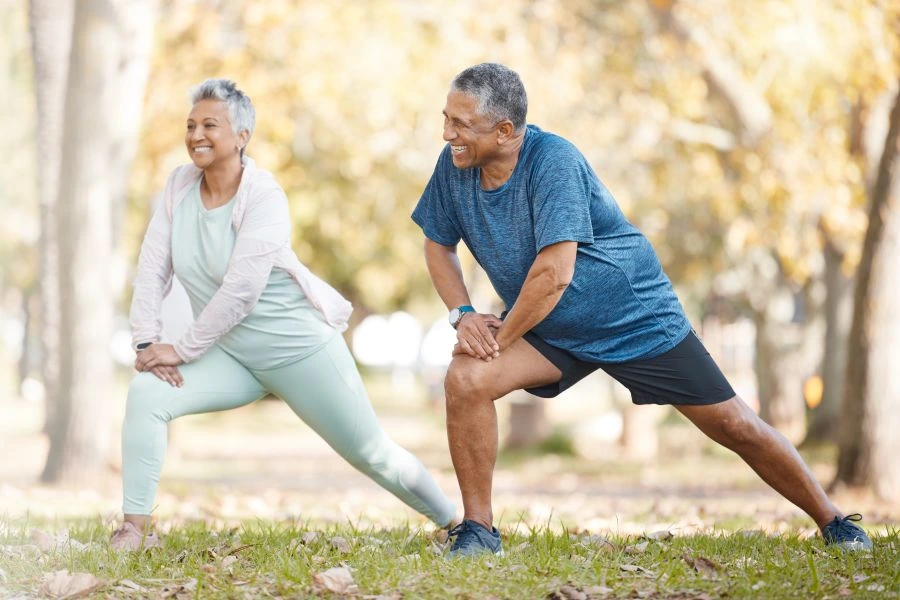 Senior man and woman doing yoga